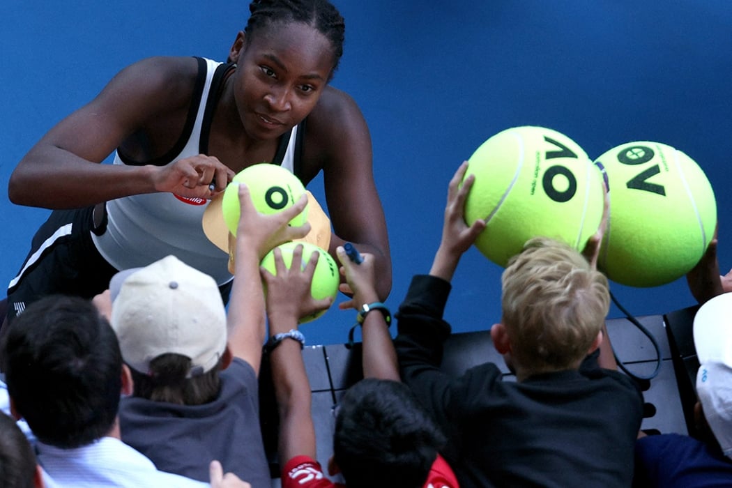 Coco Gauff signs autographs for fans at the Australian Open
