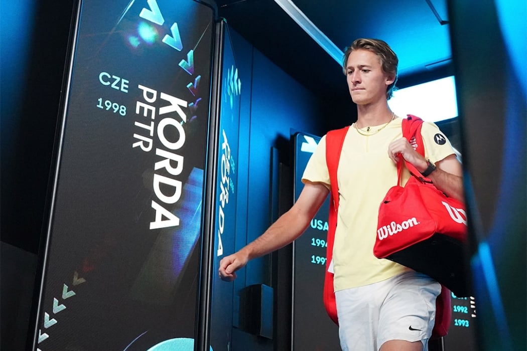 Sebastian Korda passes Petr Korda in the Walk of Champions