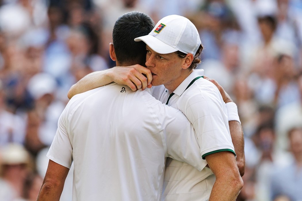 Jannik Sinner embraces Novak Djokovic after winning their Wimbledon semifinal