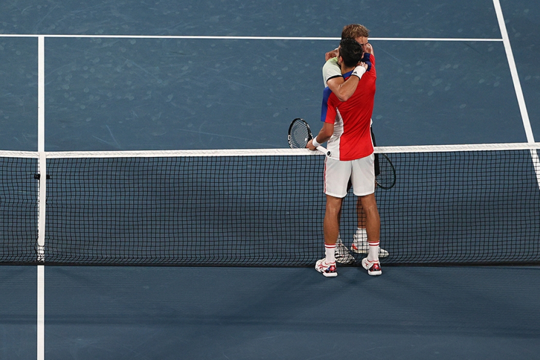 Alexander Zverev and Novak Djokovic embrace after Zverev won their Tokyo 2020 Olympics semifinal