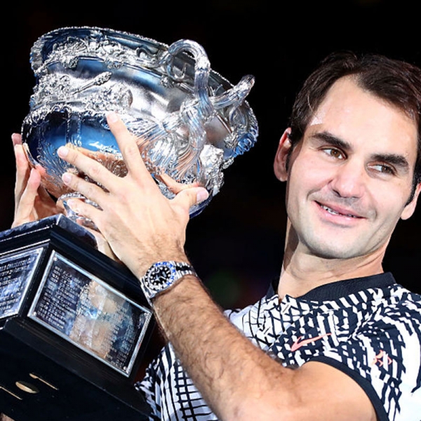 Roger Federer holds the Norman Brookes Cup
