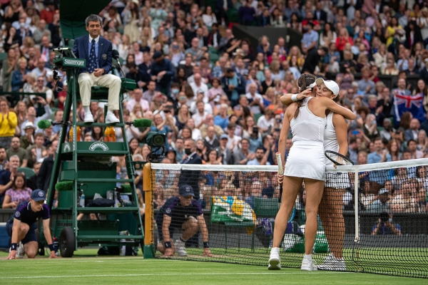 Ash Barty and Ajla Tomljanovic hug at net after their Wimbledon quarterfinal at Centre Court