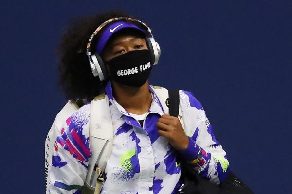 Naomi Osaka enters the court at the US Open wearing a face mask bearing the name of George Floyd