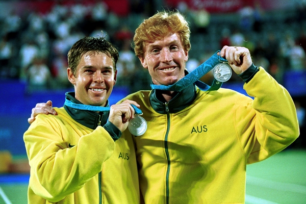Todd Woodbridge and Mark Woodforde pose with their men's doubles silver medals at the Sydney 2000 Olympics